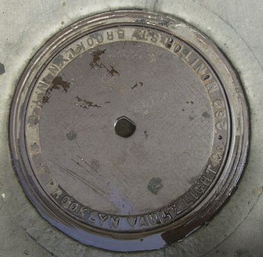 Крышка люка с надписью Brooklyn Vault Light Co. (находится у дома № 262 на Монитор-стрит в бруклинском районе Гринпойнт)