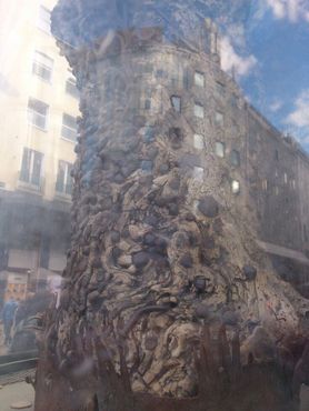 Необычное слияние дерева с отражением здания в стекле